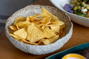 Handmade textured stoneware serving bowl with creamy glazed interior.