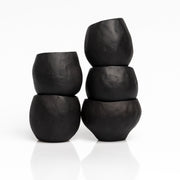     Handmade black stoneware sake cups with matte exterior and glossy glazed interior.