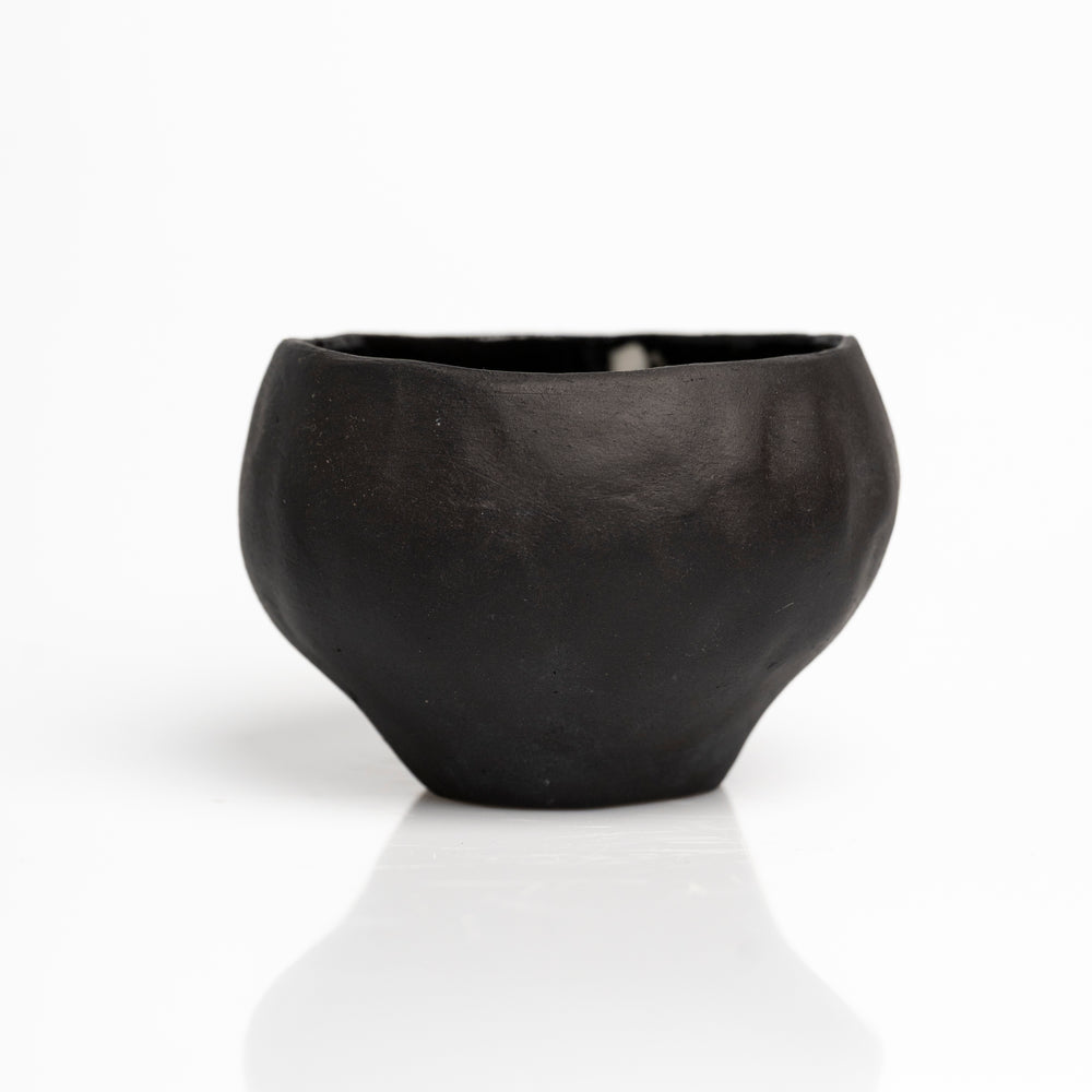    Handmade black stoneware sake cups with matte exterior and glossy glazed interior.