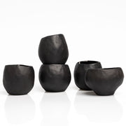    Handmade black stoneware sake cups with matte exterior and glossy glazed interior.
