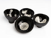     Handmade black stoneware snack bowls with unique hand-painted interiors.