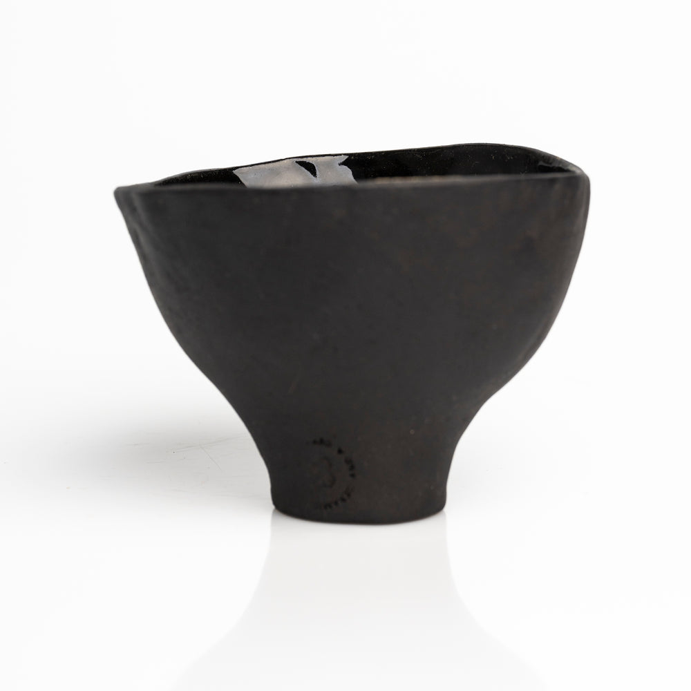     Handmade black stoneware snack bowl with unique hand-painted interiors.