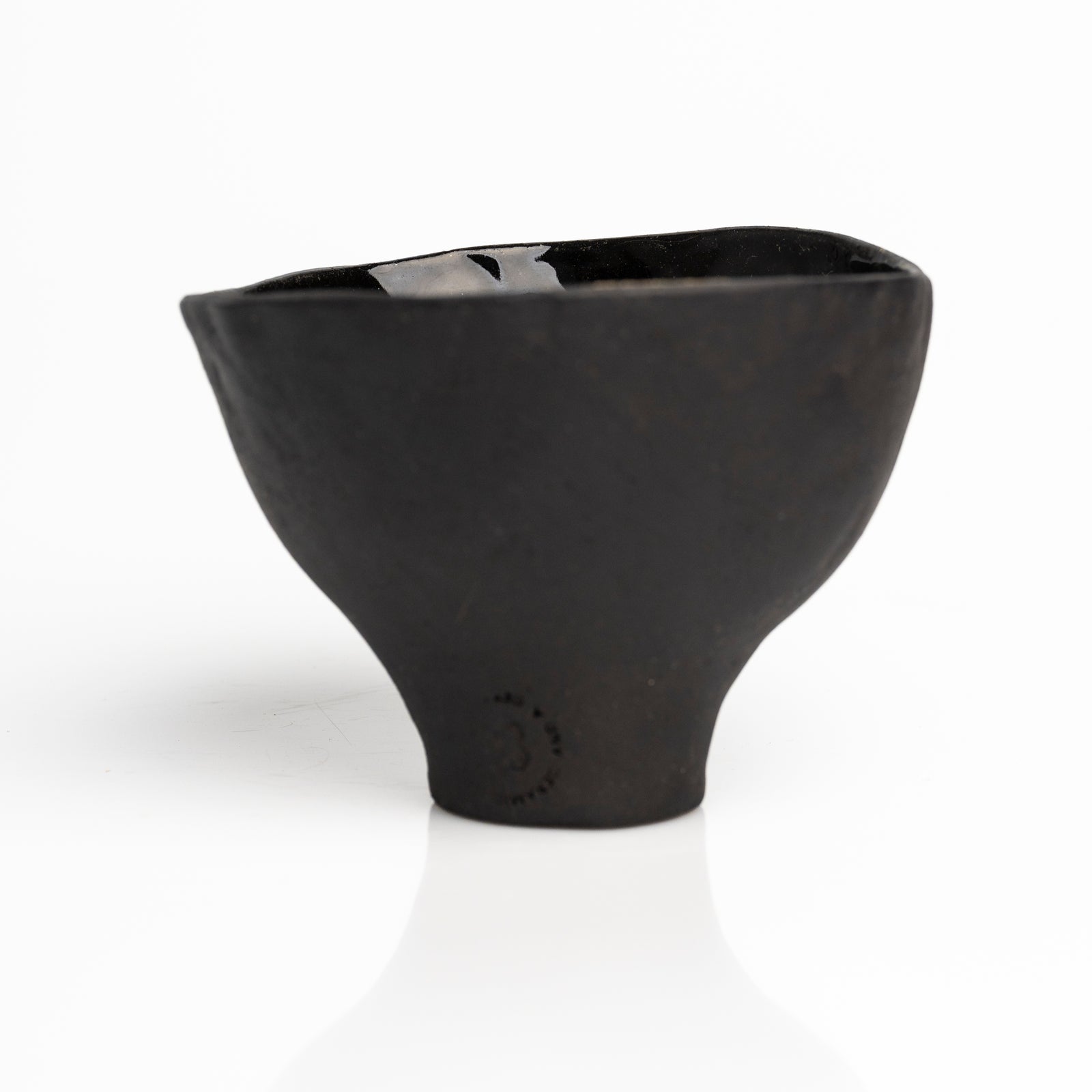     Handmade black stoneware snack bowl with unique hand-painted interiors.