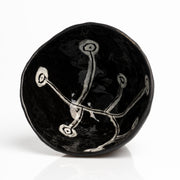     Handmade black stoneware snack bowl with unique hand-painted interiors.