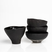     Handmade black stoneware snack bowls with unique hand-painted interiors.