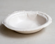     Handmade white stoneware dishes with irregular paper-like edges
* Contemporary stoneware tableware inspired by disposable paper plates
* Sculptural handmade ceramic dishes by Casa Retortillo
* Organic stoneware dish set photographed on neutral background
* Minimal handmade stoneware from the Arqueologies collection