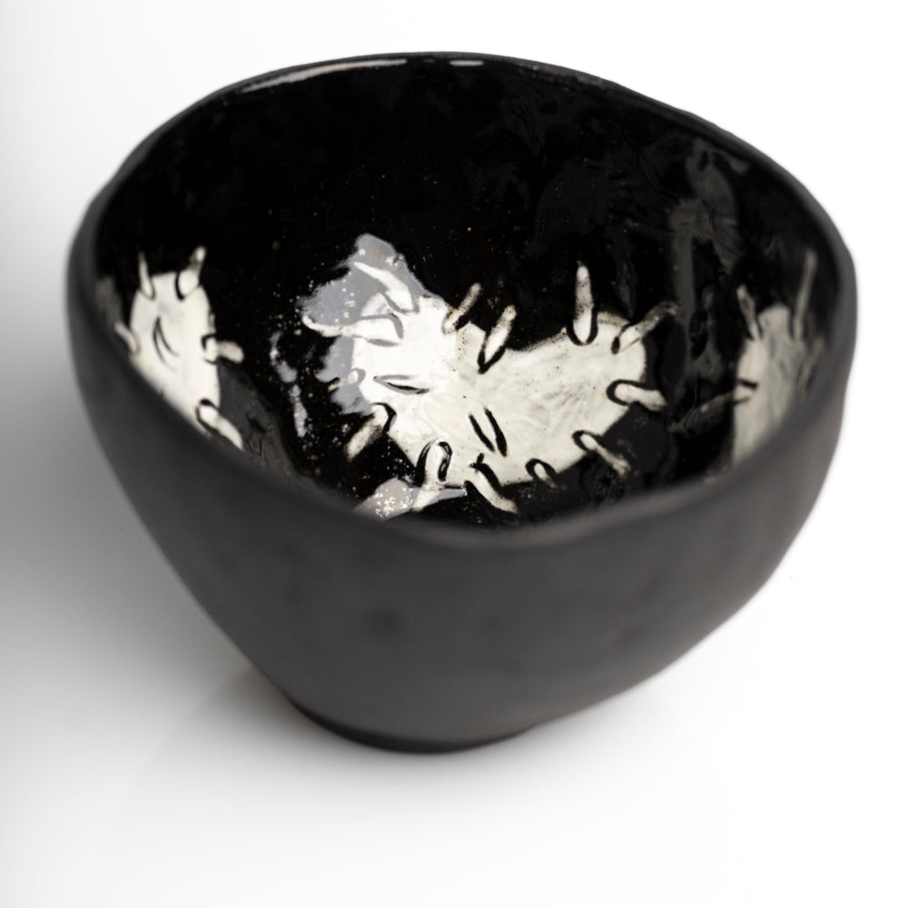     Handmade black stoneware snack bowl with unique hand-painted 