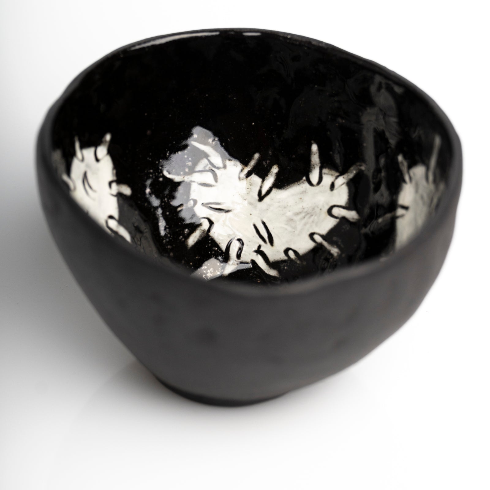     Handmade black stoneware snack bowl with unique hand-painted 