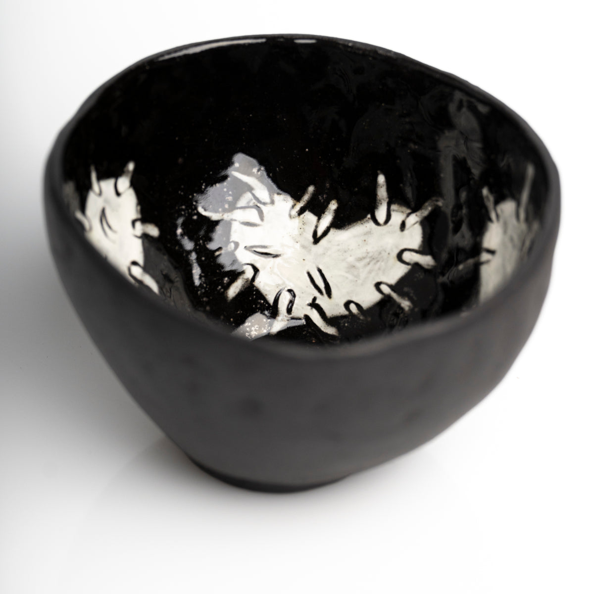     Handmade black stoneware snack bowl with unique hand-painted 