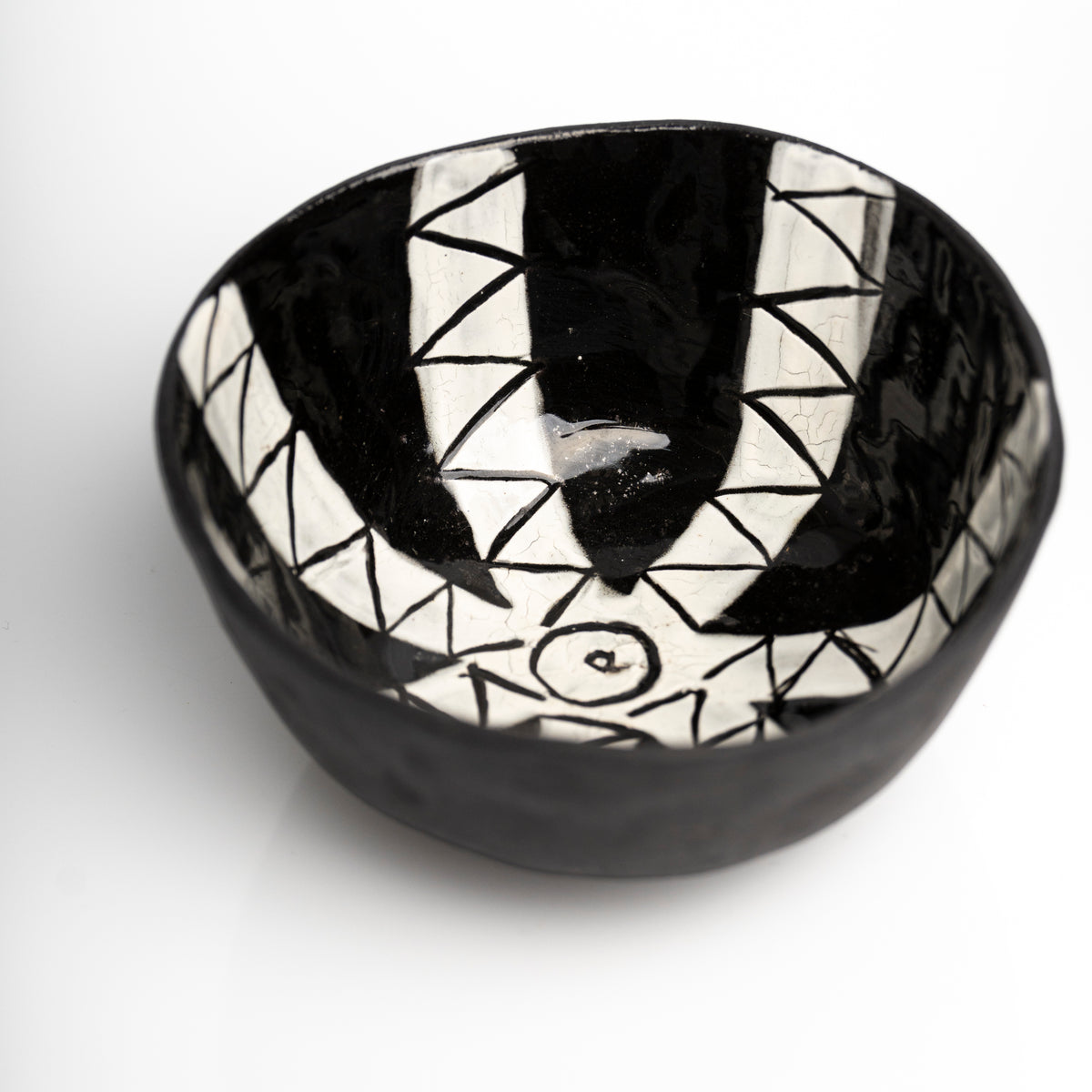     Handmade black stoneware snack bowl with unique hand-painted interiors.
