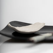     Handmade porcelain leaf dish with glossy white glaze.