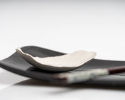     Handmade porcelain leaf dish with glossy white glaze.