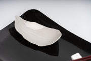     Handmade porcelain leaf dish with glossy white glaze.