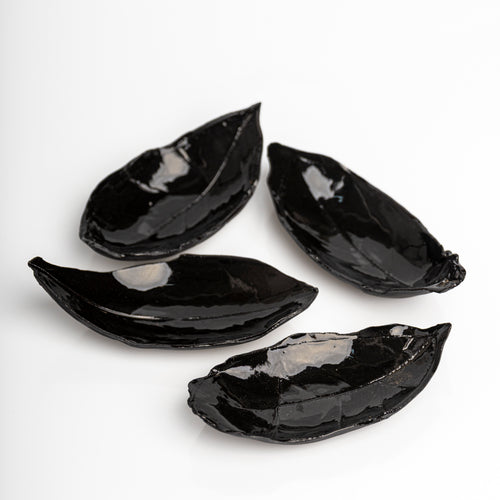     Handmade black leaf dish with glossy glaze.