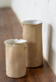     Handmade stoneware vase with corrugated textured surface
* Contemporary ceramic vessel inspired by cardboard packaging
* Sculptural handmade stoneware vase with irregular edges
* Organic textured ceramic object by Casa Retortillo
* Minimal stoneware vase from the Arqueologies collection