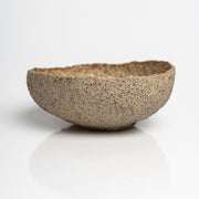 Handmade textured stoneware serving bowl with creamy glazed interior.