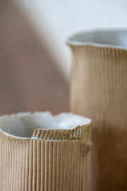     Handmade stoneware vase with corrugated textured surface
* Contemporary ceramic vessel inspired by cardboard packaging
* Sculptural handmade stoneware vase with irregular edges
* Organic textured ceramic object by Casa Retortillo
* Minimal stoneware vase from the Arqueologies collection