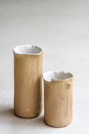     Handmade stoneware vase with corrugated textured surface
* Contemporary ceramic vessel inspired by cardboard packaging
* Sculptural handmade stoneware vase with irregular edges
* Organic textured ceramic object by Casa Retortillo
* Minimal stoneware vase from the Arqueologies collection