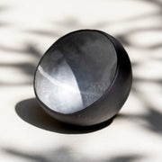     Artisan ceramic chawan with asymmetrical form and contrasting black and white finish.